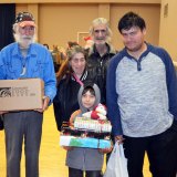 Twelve-year-old Alexander Patron with members of his family Friday leaves with a bunch of presents from the "Reason for the Season."